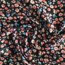 POPELINE DI COTONE FANTASIA - 087 FIORELLINO ARANCIO FONDO NERO A POIS